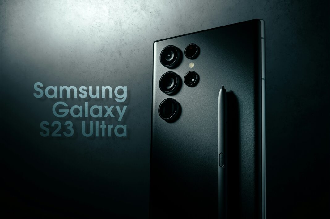 Samsung Galaxy S23 Ultra smartphone showing rear cameras and stylus pen in a dark setting with the phone's name beside it